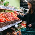 woman in face mask shopping in supermarket